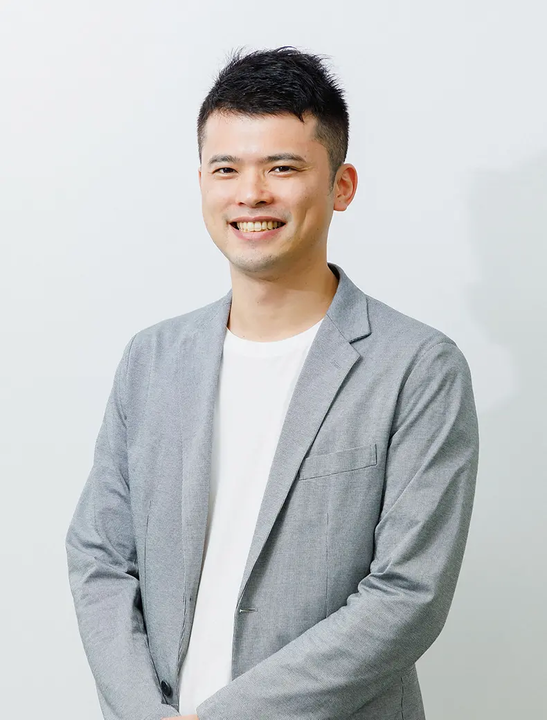 白い背景で撮影された、Findy代表取締役の山田裕一郎氏のプロフィール写真。黒のジャケットと水色のシャツを着用した、信頼感のある表情のビジネスポートレート